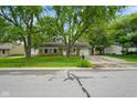 Traditional brick ranch home on a tree-lined street with a charming front porch at 99 Old Trail Dr, Bargersville, IN 46106