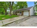 Inviting brick home features a one-car garage and a cozy front porch with rocking chairs at 99 Old Trail Dr, Bargersville, IN 46106