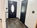 Home entryway featuring wood-look floors and black trim at 100 Justin Dr, Mooresville, IN 46158