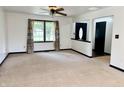 Bright, open living room with large window and neutral carpeting at 100 Justin Dr, Mooresville, IN 46158