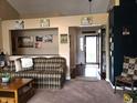 Cozy living room featuring neutral carpet, a couch, and an entryway view at 1027 Springway Dr, Shelbyville, IN 46176