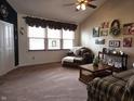 Bright living room featuring a large window, vaulted ceiling, and neutral carpet at 1027 Springway Dr, Shelbyville, IN 46176