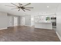 Open-concept living room flows into a kitchen with white cabinets and an island featuring pendant lighting at 10727 N Shupe Rd, Monrovia, IN 46157