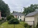 Fenced backyard featuring mature trees and a detached garage at 111 S Jefferson St, Brownsburg, IN 46112
