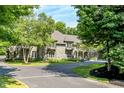 Lush greenery surrounds this beautiful stone home with its large windows and balconies at 11557 Willow Springs Dr, Zionsville, IN 46077