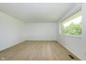 Clean, spacious room featuring neutral carpet, a large window bringing in natural light, and freshly painted walls at 1217 S Post Rd, Indianapolis, IN 46239