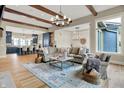 Spacious living room with hardwood floors, beamed ceiling and seamless connection to kitchen at 12839 Bird Cage, Carmel, IN 46032