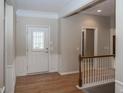 Welcoming foyer with hardwood floors, traditional wainscoting, and staircase to the second level at 12880 Oxbridge Pl, Fishers, IN 46037