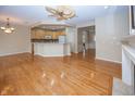 Spacious living area with hardwood floors seamlessly flowing into the kitchen and dining spaces at 12880 Oxbridge Pl, Fishers, IN 46037