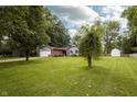 Quaint home featuring a well-kept front yard and mature trees at 13 Fairlane Dr, Brownsburg, IN 46112