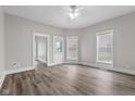 Spacious living room featuring light gray walls, new floors, and modern ceiling fan at 1310 California St, Columbus, IN 47201