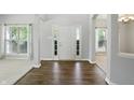 Inviting foyer with hardwood flooring and natural light streaming through the sidelight windows at 13355 Freenza Ct, Carmel, IN 46074