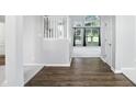 Bright hallway with hardwood floors leads to carpeted rooms with large windows at 13355 Freenza Ct, Carmel, IN 46074