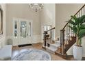 Grand foyer with soaring ceilings, hardwood floors, elegant staircase, and a beautiful chandelier creating a lasting impression at 14682 Braemar E Ave, Noblesville, IN 46062