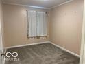Neutral carpeted bedroom with a window and neutral walls at 1610 Douglas Ln, Lebanon, IN 46052