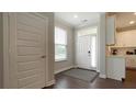 Welcoming foyer with light gray walls, wood-look floors, a white door, and a window with white blinds at 17303 Lillian St, Westfield, IN 46074