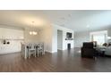 Open-concept living area featuring a fireplace, hardwood floors, modern lighting, and neutral decor at 17303 Lillian St, Westfield, IN 46074