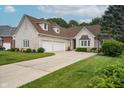 Spacious brick home with a three-car garage and a long, curved driveway leading to the entrance at 18432 Oriental Oak Ct, Noblesville, IN 46062