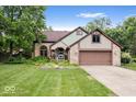 Charming two-story brick home with a well-manicured lawn and an attached two-car garage at 259 Glenbrook Ln, Avon, IN 46123