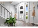 Bright foyer featuring a white door, elegant decor, and a staircase with white banisters at 259 Glenbrook Ln, Avon, IN 46123