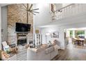 Inviting living room with a brick fireplace, vaulted ceilings, and an open layout at 259 Glenbrook Ln, Avon, IN 46123