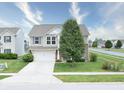 Attractive two-story home featuring a well-kept lawn, a driveway, and a mixture of siding and brick at 2615 Pumpkin Patch Ln, Indianapolis, IN 46229