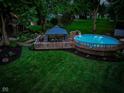 A backyard featuring a gazebo and a pool surrounded by lush greenery at 272 N Peterman Rd, Greenwood, IN 46142
