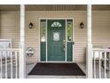 Close-up of the home's front door, featuring sidelights, decorative accents, and a welcoming ambiance at 2872 N Prairie Stream Way, Columbus, IN 47203