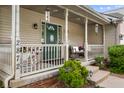 Inviting front porch with rocking chairs, decorative plants, and charming details at 2872 N Prairie Stream Way, Columbus, IN 47203