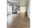 Open-concept kitchen and dining area with hardwood floors and modern white cabinets, creating an airy feel at 3813 N Lawndale Ave, Indianapolis, IN 46254
