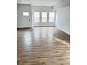 Bright living room with hardwood floors and white walls, complemented by natural light from multiple windows at 3813 N Lawndale Ave, Indianapolis, IN 46254