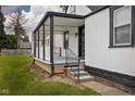 View of the cozy covered front porch, stylish railings, with a well-maintained lawn at 3822 Haverhill Dr, Anderson, IN 46013