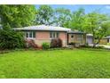 Inviting single-story home with a brick facade, tidy landscaping, and green lawn at 4340 Ashbourne Ln, Indianapolis, IN 46226