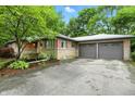 Attractive brick home with attached two-car garage and a well-maintained front yard at 4340 Ashbourne Ln, Indianapolis, IN 46226