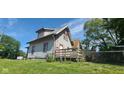 Shows the side and back of the house, highlighting the architectural details and fenced back yard at 435 N Rural Ne St, Indianapolis, IN 46201