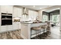 Modern kitchen with white cabinets, stainless steel appliances, and a breakfast bar with seating at 5002 Jasper Ridge Blvd, Indianapolis, IN 46235