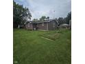 Exterior home view with well-kept lawn and garden area at 509 S E St, Arcadia, IN 46030
