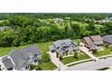 An aerial view of a beautiful two-story home featuring a manicured lawn and close proximity to nearby neighborhood at 5706 Bentbrook Dr, Bargersville, IN 46106