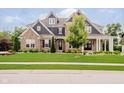 Charming two-story home boasts beautiful stone and siding, professional landscaping, and a well-manicured lawn at 5706 Bentbrook Dr, Bargersville, IN 46106