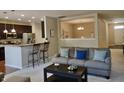 Open-concept living area with kitchen view, breakfast bar seating, and neutral decor at 5932 Edelle Dr, Indianapolis, IN 46237