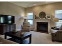 Comfortable living room featuring a fireplace, stylish furniture, and natural light at 5932 Edelle Dr, Indianapolis, IN 46237