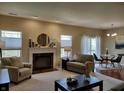 Bright living room features fireplace, large windows, and access to the outdoor space at 5932 Edelle Dr, Indianapolis, IN 46237