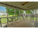 Relaxing screened patio featuring a wooden floor and comfortable seating arrangement at 6937 Thousand Oaks Dr, Indianapolis, IN 46214