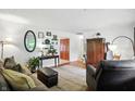 Inviting living room with warm wood floors, plush seating, and stylish decor accents at 7113 Chandler Dr, Indianapolis, IN 46217