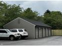 A view of the attached garages to the building with a new fence alongside at 7220 Village Pkwy Dr # 3, Indianapolis, IN 46254