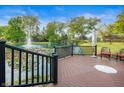 Serene backyard setting with a pond, fountain, waterfall, and wooden deck with chairs at 7601 Newport Bay Dr # 115, Indianapolis, IN 46240