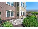Inviting patio features stone paving, garden beds, seating, and access to the home's exterior at 7601 Newport Bay Dr # 115, Indianapolis, IN 46240