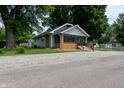 This charming home features a well-manicured lawn and inviting curb appeal at 7727 Huff St, Indianapolis, IN 46259