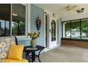 Inviting front porch adorned with seating, flowers, and charming decor at 7727 Huff St, Indianapolis, IN 46259