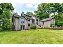 A view of the house from the back reveals a large lot with mature trees at 8004 Lafayette Rd, Indianapolis, IN 46278